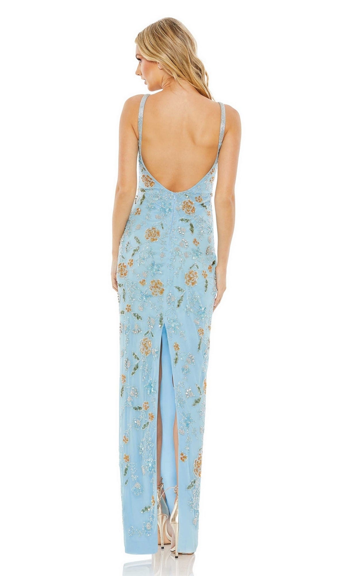 A woman stands facing away, wearing the Long Formal Dress 10808 by Mac Duggal—a light blue, sleeveless dress with a floral pattern, open low back, and back slit.